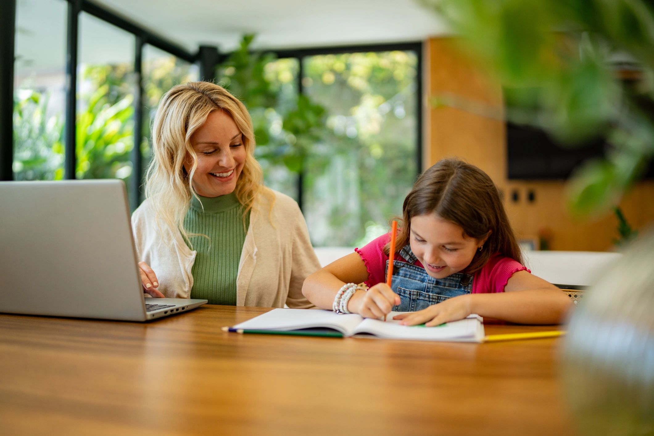 Parent and child learning together at a laptop