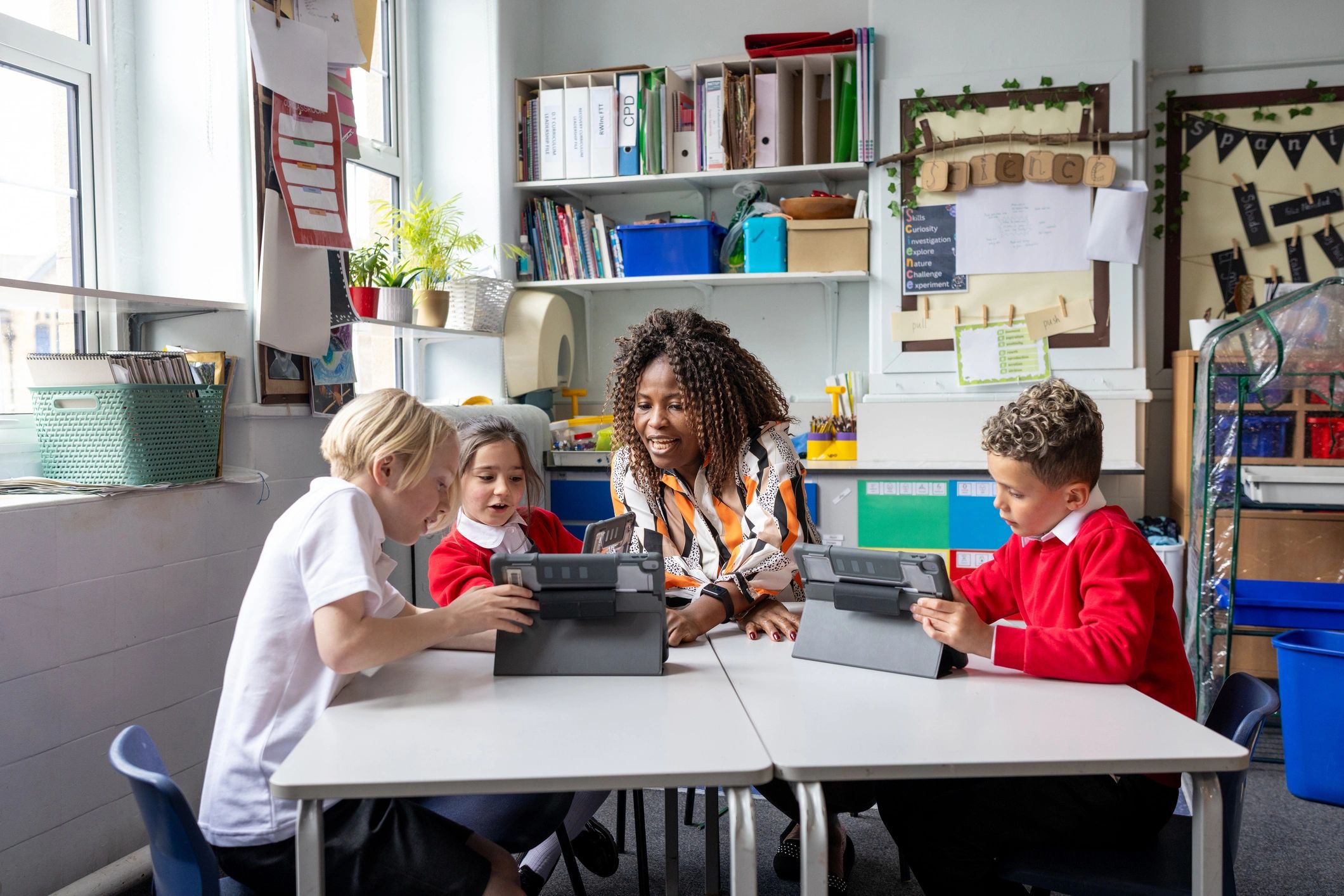 Learners using tablets with teacher support