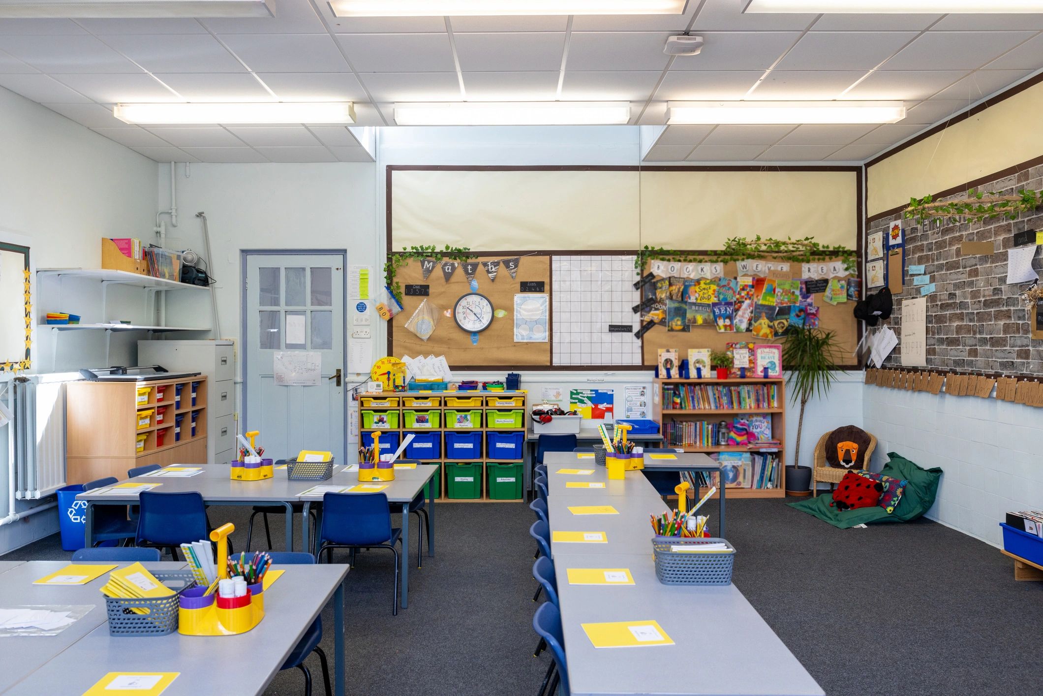 Classroom desks prepared with learning supplies