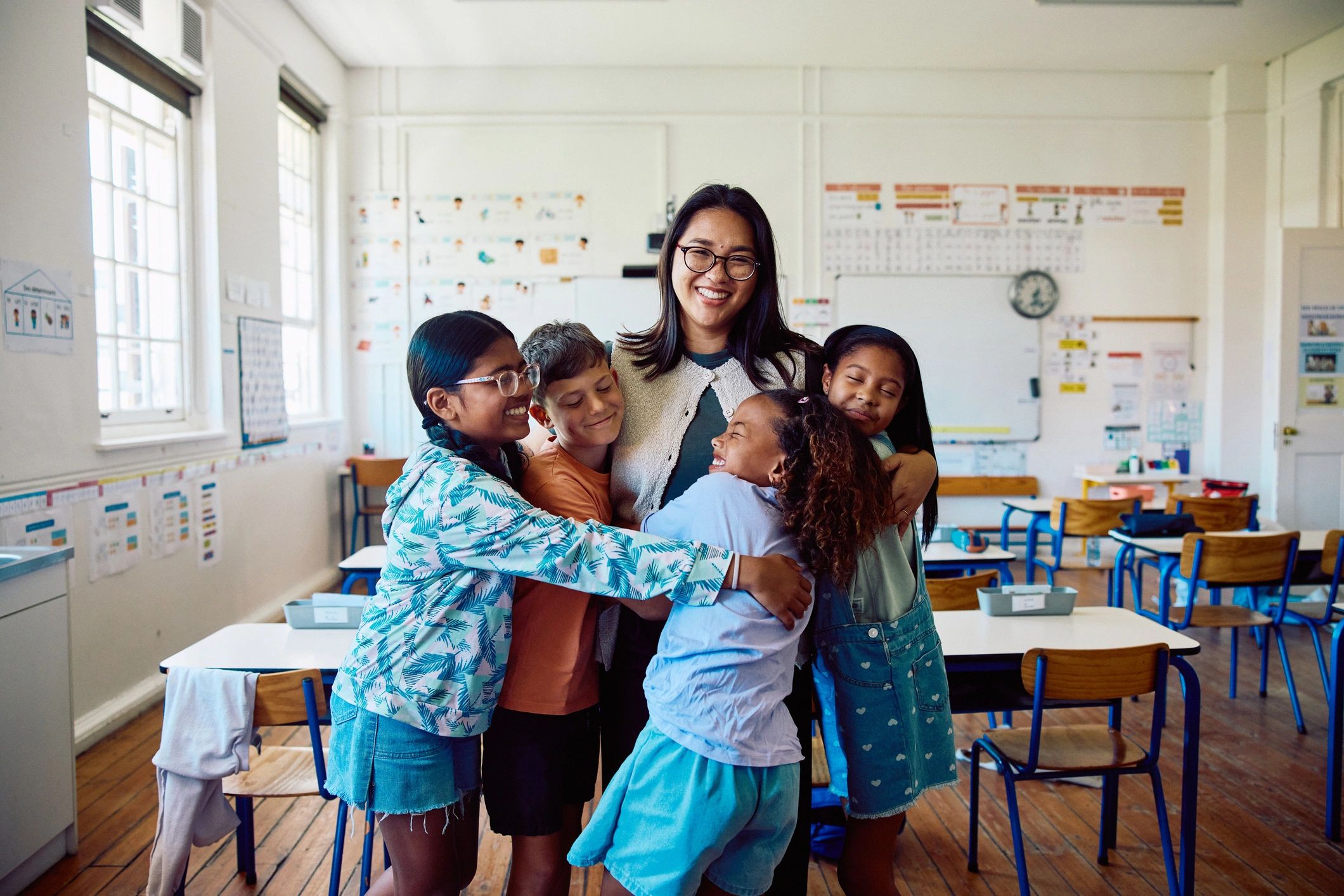 Happy teacher in classroom for testimonial