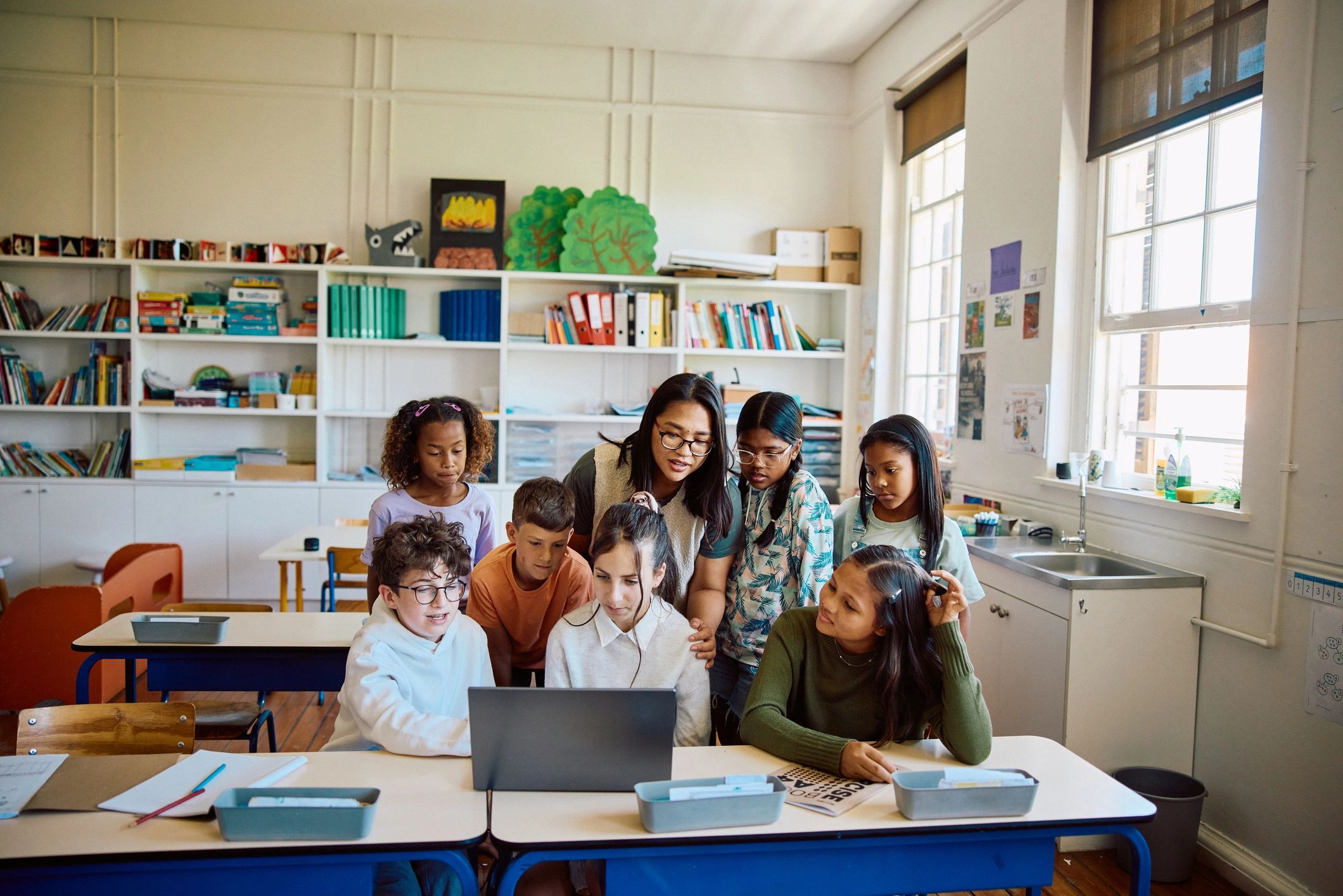 Teacher guiding learners during a collaborative classroom activity